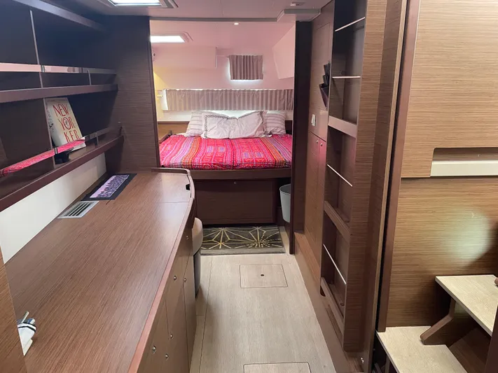 Hullchal Yacht Photos Pics Interior of 2021 Lagoon 42 yacht with cozy bedroom and wooden furnishings.