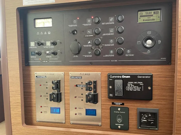 Hullchal Yacht Photos Pics Control panel of a 2021 Lagoon 42 yacht, featuring various switches and a Cummins Onan generator.