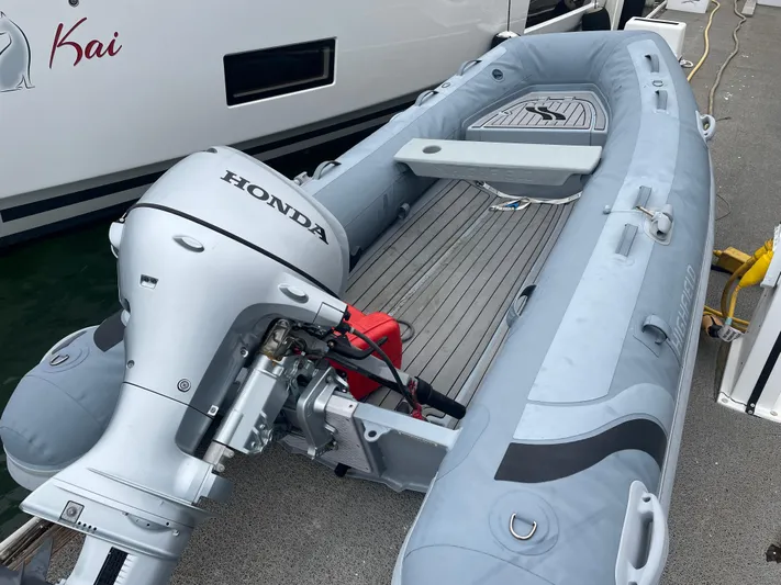 Hullchal Yacht Photos Pics Inflatable boat with Honda outboard motor beside Lagoon 42 yacht, 2021 model.