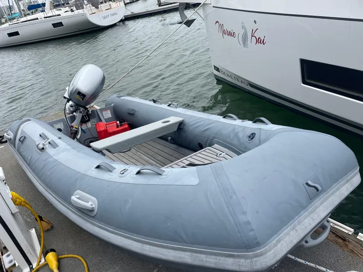 Hullchal Yacht Photos Pics Inflatable dinghy moored beside a 2021 Lagoon 42 catamaran in a marina.