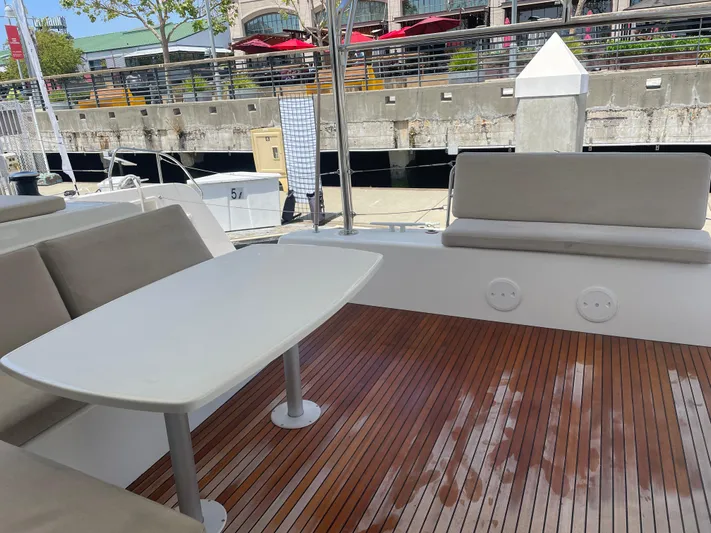 Hullchal Yacht Photos Pics Lagoon 42 (2021) yacht deck with seating and table, docked at marina.