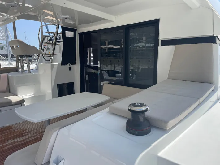 Hullchal Yacht Photos Pics 2021 Lagoon 42 yacht deck with seating and table, showcasing modern design and comfort.