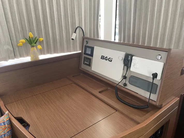 Hullchal Yacht Photos Pics Lagoon 42 (2021) yacht interior with navigation panel and vase of yellow tulips.