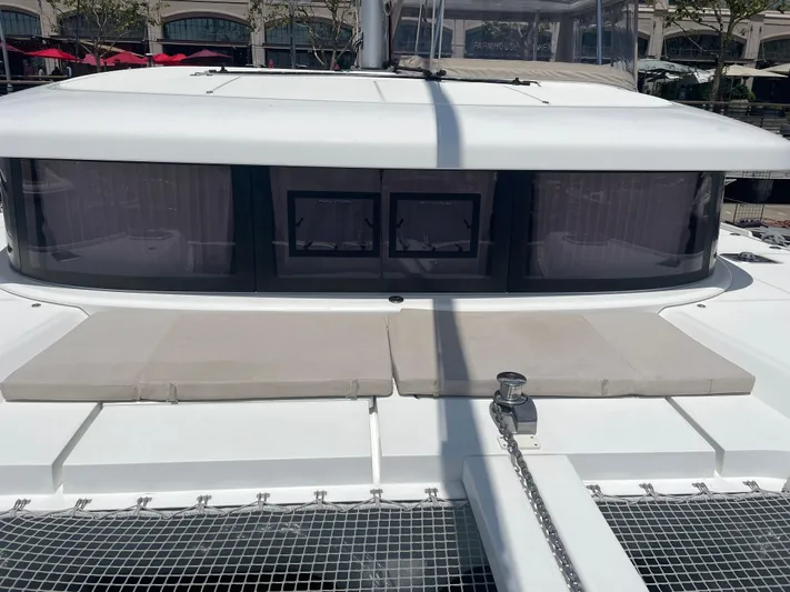 Hullchal Yacht Photos Pics 2021 Lagoon 42 catamaran deck with sunbathing area and netting.