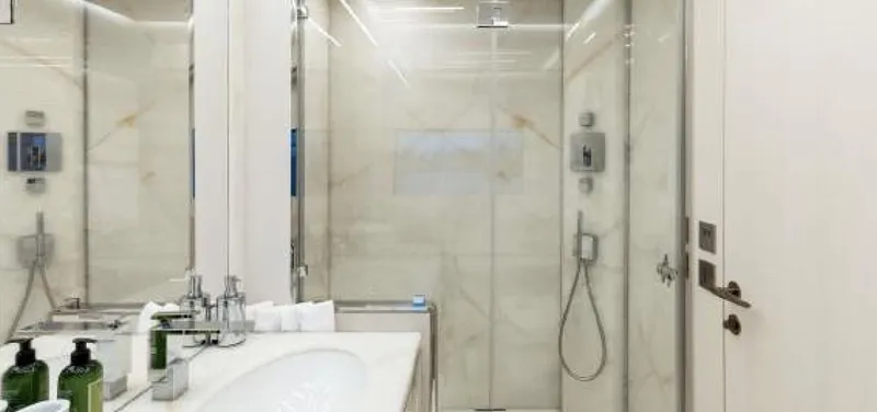 N1 Yacht Photos Pics Luxurious bathroom interior of 2022 Mangusta 165 REV yacht with modern fixtures and marble accents.