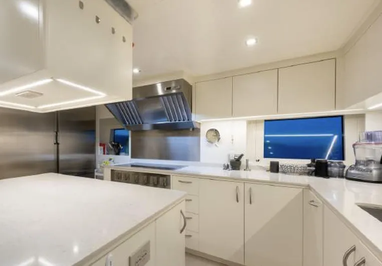 N1 Yacht Photos Pics Luxurious kitchen interior on 2022 Mangusta 165 REV yacht, featuring modern appliances and sleek design.