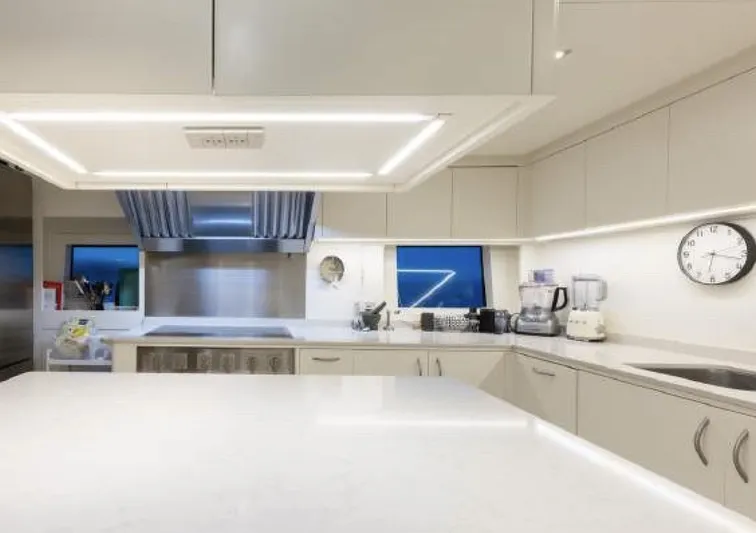 N1 Yacht Photos Pics Luxurious kitchen interior of 2022 Mangusta 165 REV yacht, featuring modern appliances and sleek design.