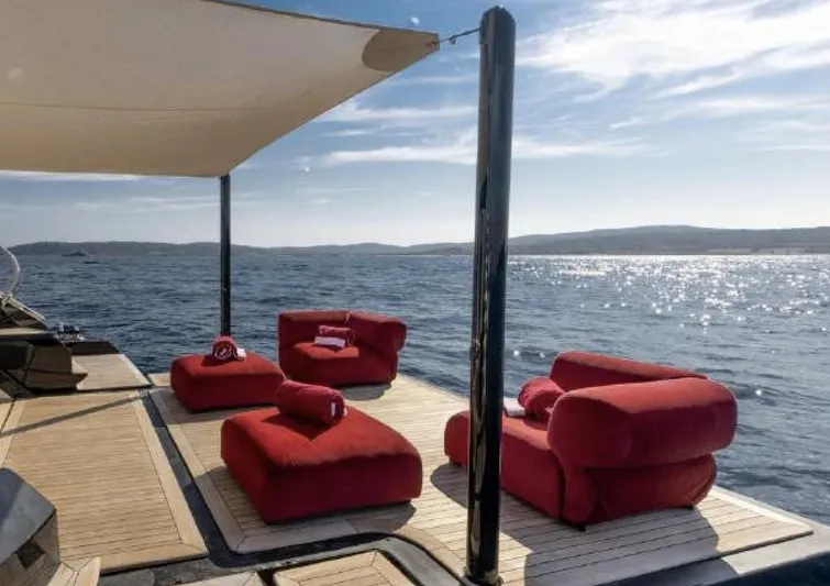 N1 Yacht Photos Pics Luxury deck of 2022 Mangusta 165 REV yacht with red seating and ocean view.