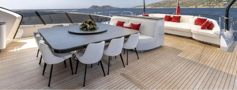 N1 Yacht Photos Pics Luxurious 2022 Mangusta 165 REV yacht deck with elegant dining area and scenic ocean view.