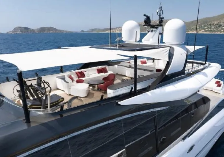N1 Yacht Photos Pics Luxurious 2022 Mangusta 165 REV yacht with elegant deck seating and ocean backdrop.