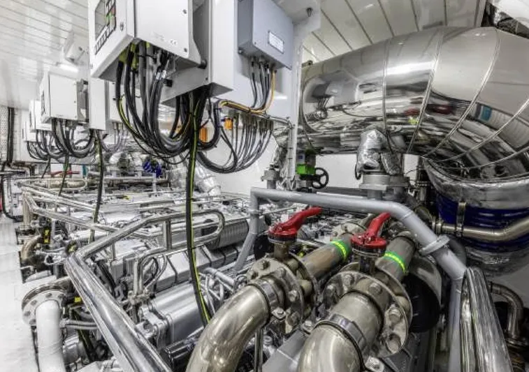 N1 Yacht Photos Pics Engine room of 2022 Mangusta 165 REV yacht, featuring advanced machinery and piping.