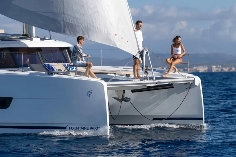  Yacht Photos Pics 2026 Fountaine Pajot FP 44 catamaran sailing with three people on deck.