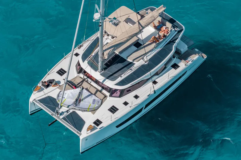  Yacht Photos Pics 2026 Fountaine Pajot FP 44 catamaran sailing on clear turquoise waters.