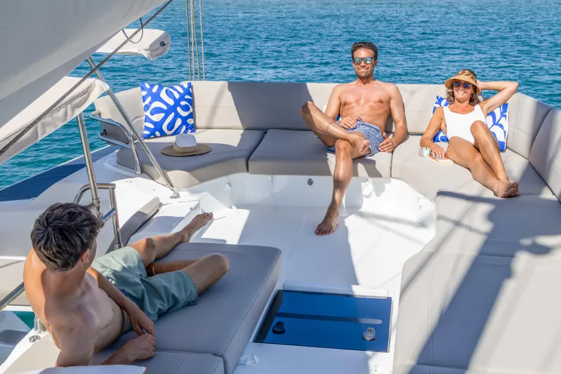 Yacht Photos Pics People relaxing on a 2026 Fountaine Pajot FP 44 yacht under the sun.