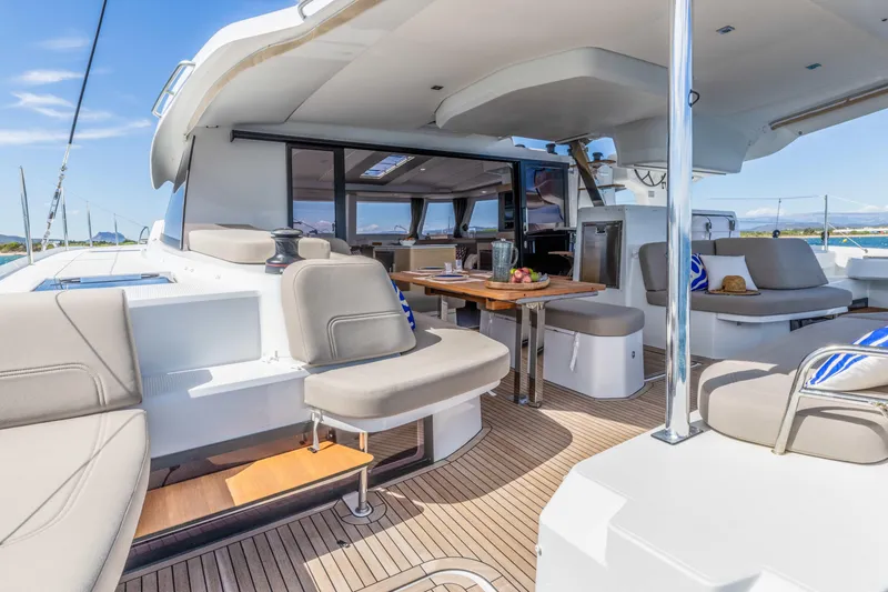  Yacht Photos Pics Luxurious 2026 Fountaine Pajot FP 44 yacht interior with elegant seating and dining area.