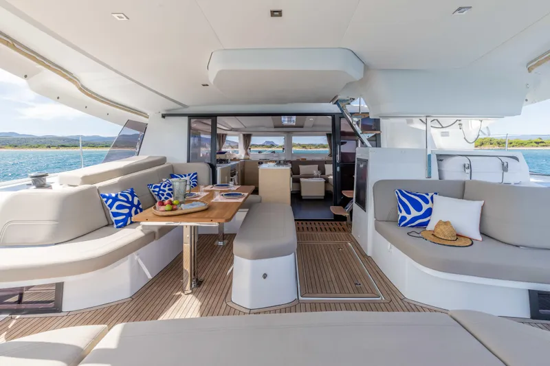  Yacht Photos Pics Luxurious 2026 Fountaine Pajot FP 44 yacht interior with elegant seating and dining area.