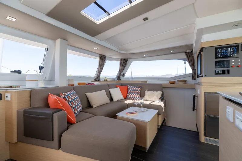  Yacht Photos Pics Luxurious interior of 2026 Fountaine Pajot FP 44 catamaran with modern seating and decor.