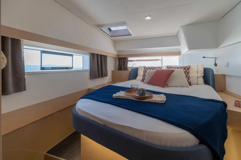  Yacht Photos Pics Luxurious bedroom interior of 2026 Fountaine Pajot FP 44 yacht with modern decor.