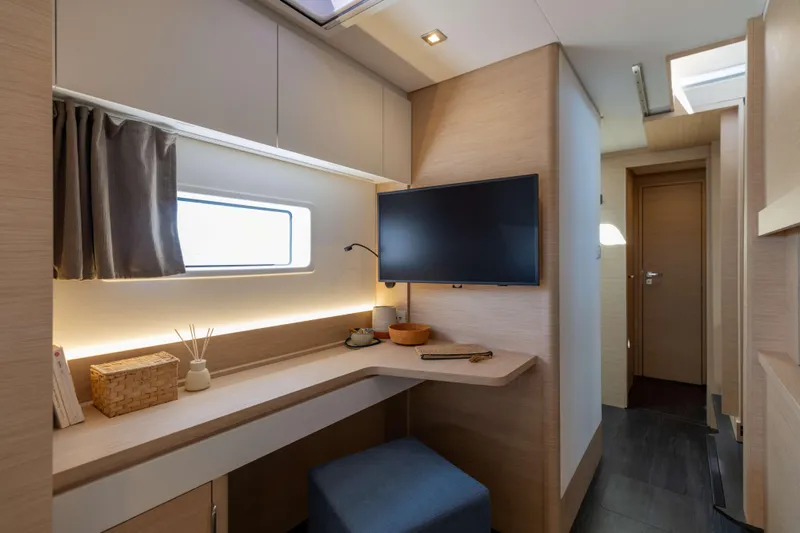  Yacht Photos Pics Luxurious interior of 2026 Fountaine Pajot FP 44 yacht with modern decor and TV.