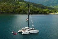 Marsaudon Composites T 50 Catamaran, 2005, anchored in a serene tropical bay.