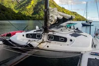 Marsaudon Composites T 50 Catamaran, 2005, docked in scenic tropical bay with lush hills.