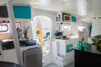 Interior of 2005 Marsaudon Composites T 50 Catamaran with modern kitchen and dining area.