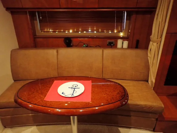 Knot Justified Yacht Photos Pics Interior of 2006 Sea Ray 38 Sundancer with sofa and oval table.