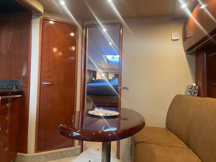 Knot Justified Yacht Photos Pics Interior of 2006 Sea Ray 38 Sundancer yacht with cozy seating and wooden finishes.