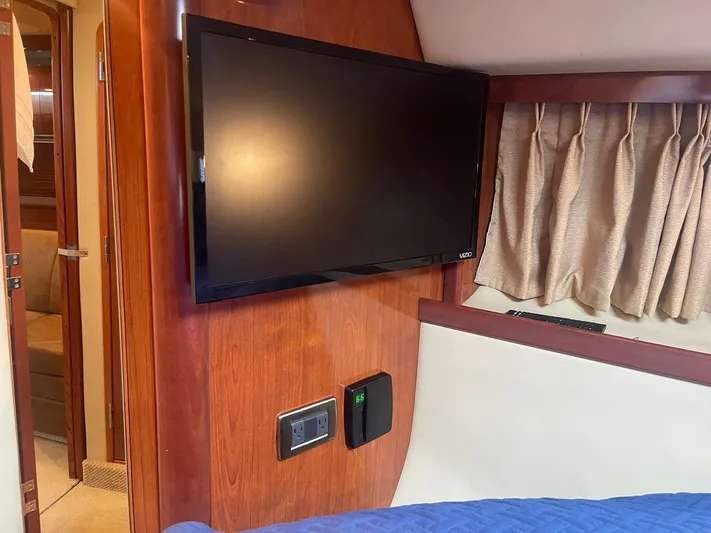 Knot Justified Yacht Photos Pics Interior of 2006 Sea Ray 38 Sundancer with mounted TV and wood paneling.