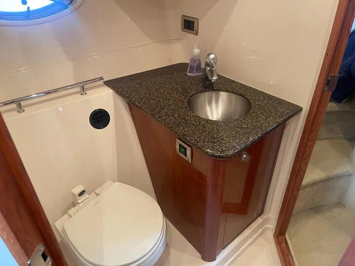 Knot Justified Yacht Photos Pics Bathroom interior of 2006 Sea Ray 38 Sundancer yacht with sink and toilet.