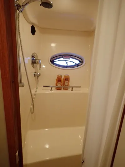 Knot Justified Yacht Photos Pics Shower area in 2006 Sea Ray 38 Sundancer yacht with porthole and toiletries.