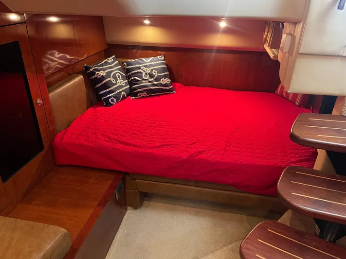Knot Justified Yacht Photos Pics Interior cabin of 2006 Sea Ray 38 Sundancer with red bedding and nautical pillows.