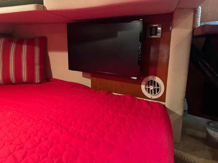 Knot Justified Yacht Photos Pics Interior of 2006 Sea Ray 38 Sundancer with red bedding and wall-mounted TV.