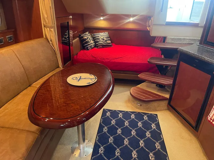 Knot Justified Yacht Photos Pics Luxurious interior of 2006 Sea Ray 38 Sundancer with red bedding and elegant wood finishes.