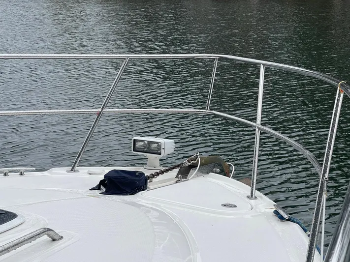 Knot Justified Yacht Photos Pics Bow of 2006 Sea Ray 38 Sundancer yacht on calm water.