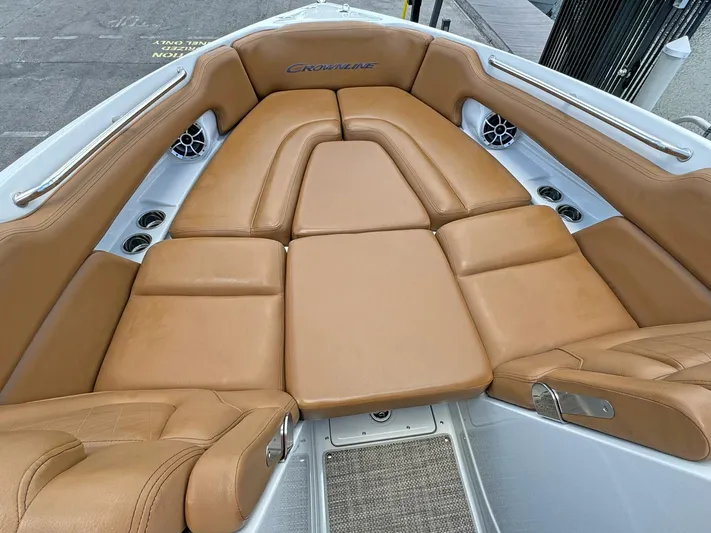  Yacht Photos Pics 2024 Crownline 290 XSS boat interior with tan leather seating and built-in speakers.
