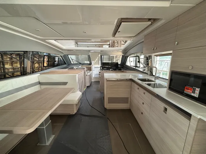 Yacht Photos Pics Interior of 2025 Aquila 42 Coupe yacht with modern kitchen and dining area.