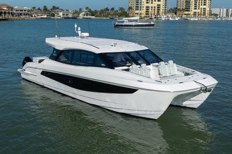  Yacht Photos Pics 2025 Aquila 42 Coupe yacht on calm water, with modern design and luxurious features.