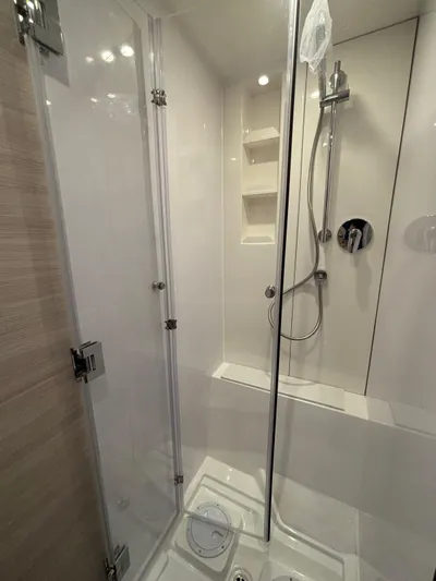  Yacht Photos Pics Modern shower in 2025 Aquila 42 Coupe yacht, featuring sleek glass doors and chrome fixtures.