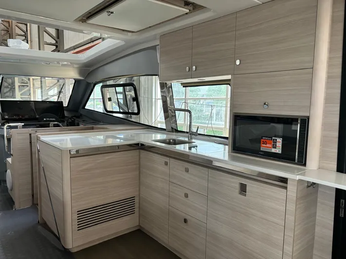  Yacht Photos Pics Modern kitchen interior of 2025 Aquila 42 Coupe yacht with sleek cabinetry and appliances.