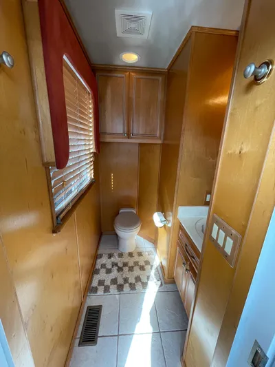  Yacht Photos Pics 2002 Stardust Cruisers houseboat bathroom with wooden cabinets and tiled floor.