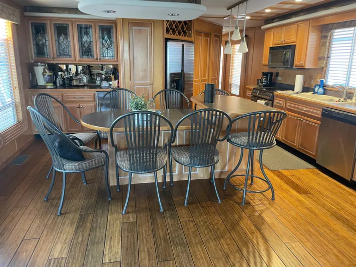  Yacht Photos Pics Spacious kitchen in a 2002 Stardust Cruisers houseboat with wooden flooring and modern appliances.
