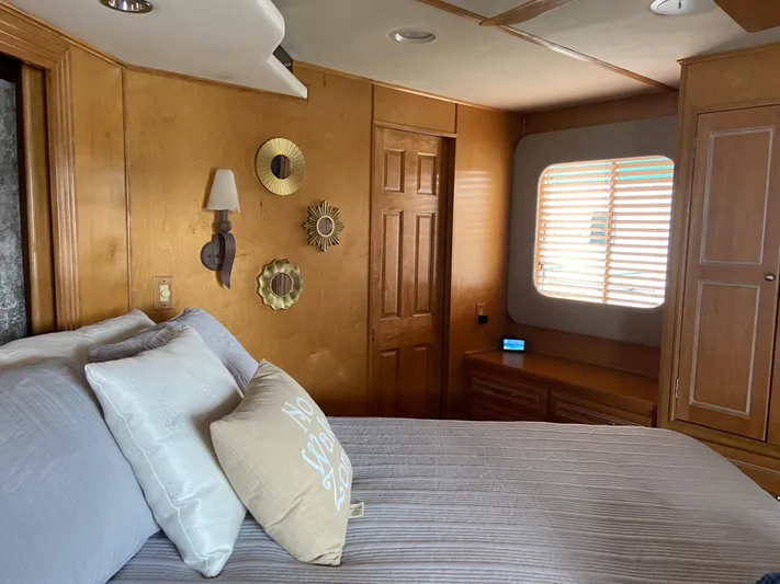  Yacht Photos Pics Cozy bedroom in a 2002 Stardust Cruisers houseboat with wooden decor and natural light.