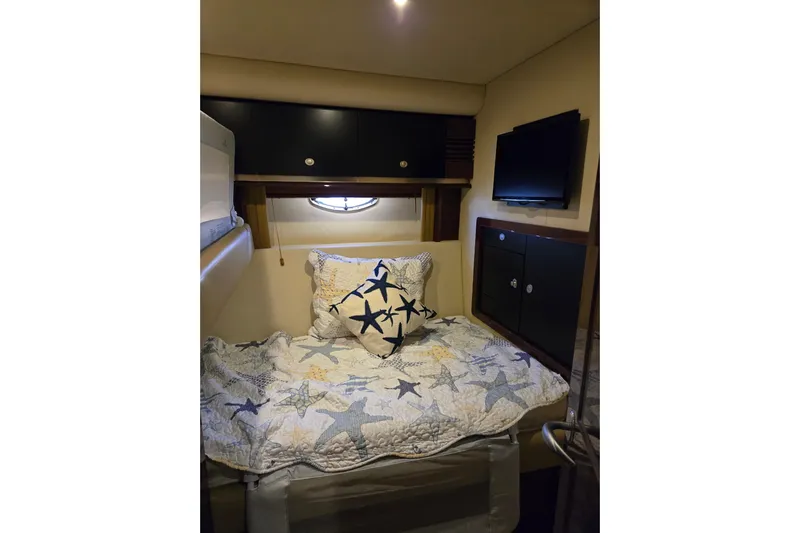  Yacht Photos Pics Cozy cabin interior of 2007 Sea Ray 580 Sedan Bridge with starfish-themed bedding.