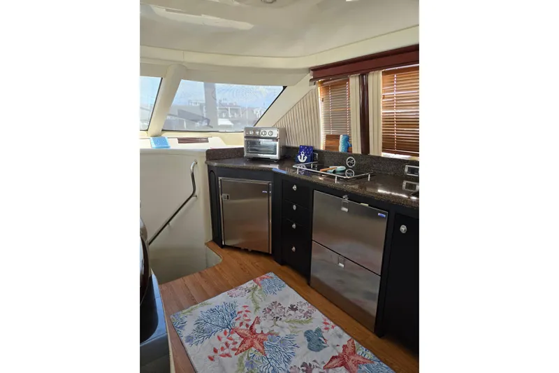  Yacht Photos Pics Interior of 2007 Sea Ray 580 Sedan Bridge with modern kitchen and nautical decor.
