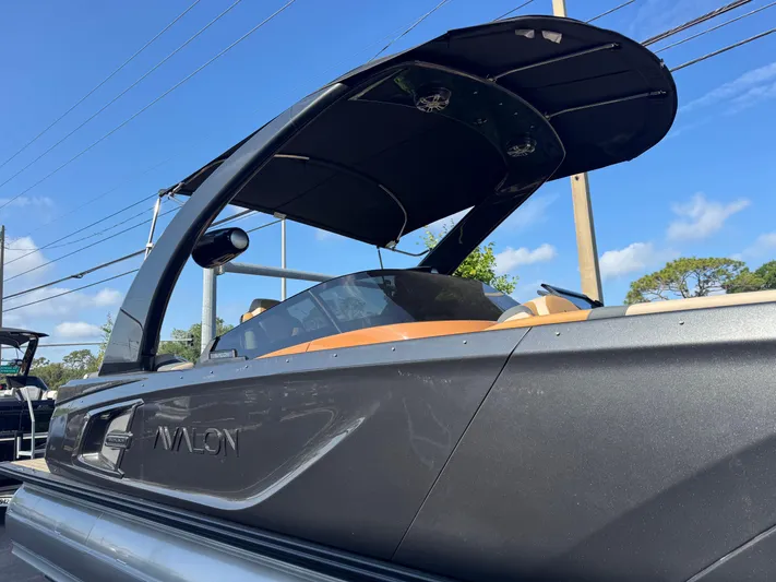  Yacht Photos Pics 2025 Avalon Excalibur 27' boat with sleek design and modern canopy.