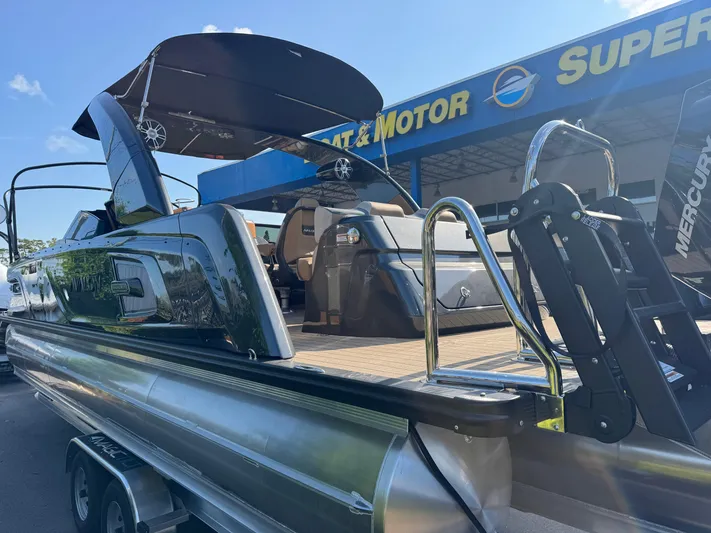  Yacht Photos Pics 2025 Avalon Excalibur 27' boat at dealership, featuring sleek design and modern amenities.