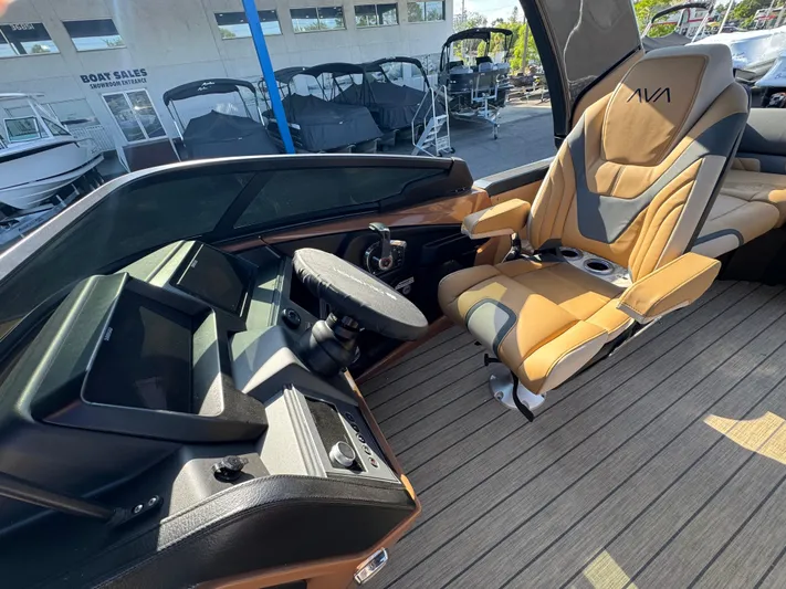  Yacht Photos Pics 2025 Avalon Excalibur 27' boat interior with modern helm and luxurious captain's chair.