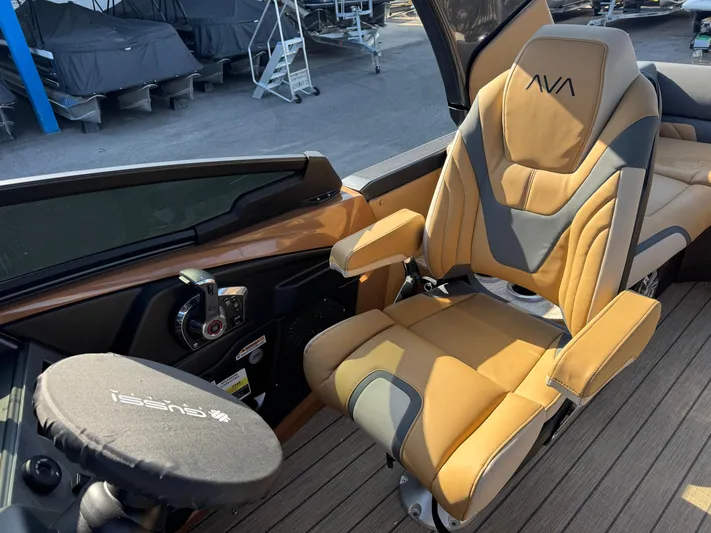  Yacht Photos Pics 2025 Avalon Excalibur boat interior with luxurious captain's chair and steering wheel.