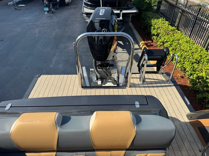  Yacht Photos Pics 2025 Avalon Excalibur 27' boat with sleek seating and powerful outboard motor.